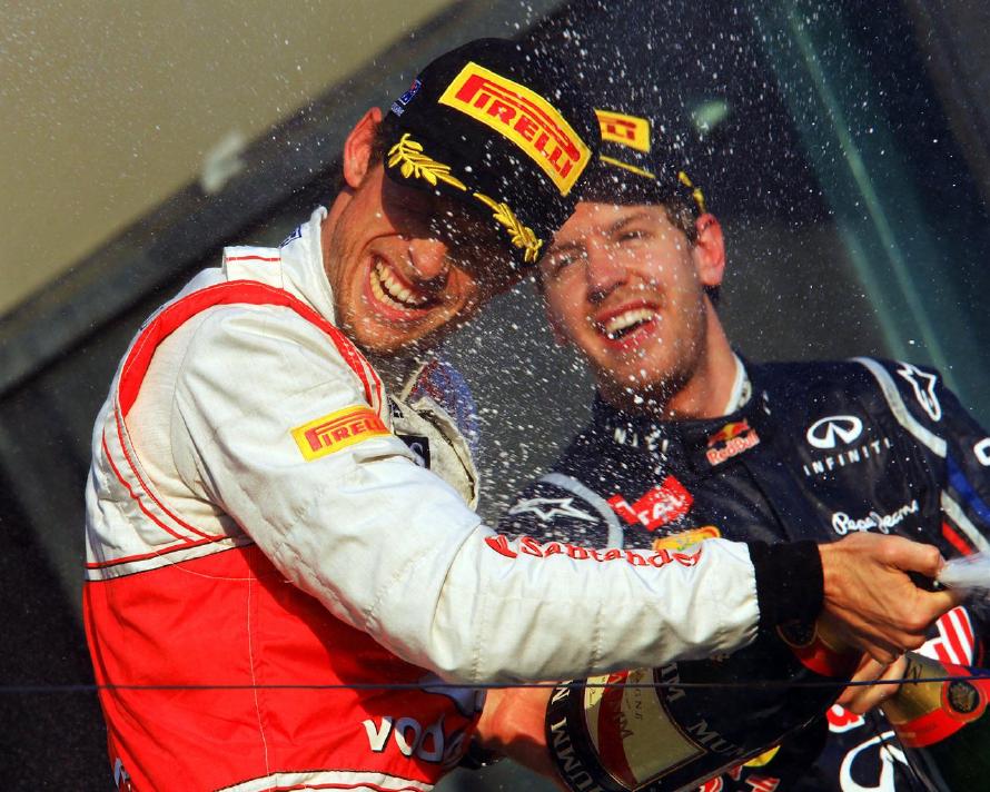 Race winner Jenson Button (GBR) McLaren, with second placed Sebastian Vettel (GER) Red Bull Racing, on the podium. Formula One World Championship, Rd1, Australian Grand Prix, Race, Albert Park, Melbourne, Australia, Sunday, 18 March 2012. © Sutton Images. No reproduction without permission.