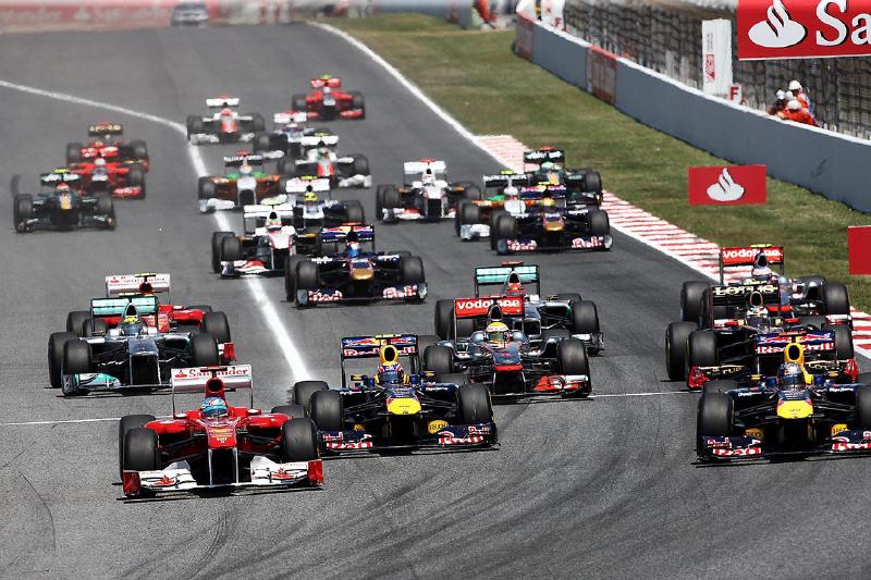 (L to R): Fernando Alonso (ESP) Ferrari 150 Italia passes Mark Webber (AUS) Red Bull Racing RB7 and Sebastian Vettel (GER) Red Bull Racing RB7 to take the lead at the start ofthe race. Formula One World Championship, Rd 5, Spanish Grand Prix, Race, Barcelona, Spain, Sunday, 22 May 2011