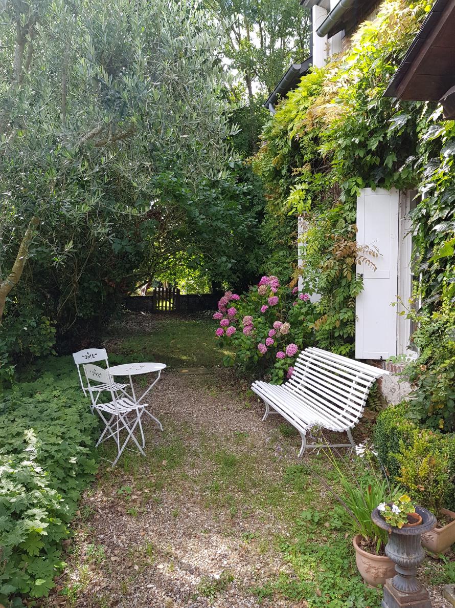 Cozy entrance with a small, white chair in front of it.