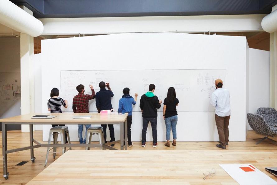 People in front of a white board.