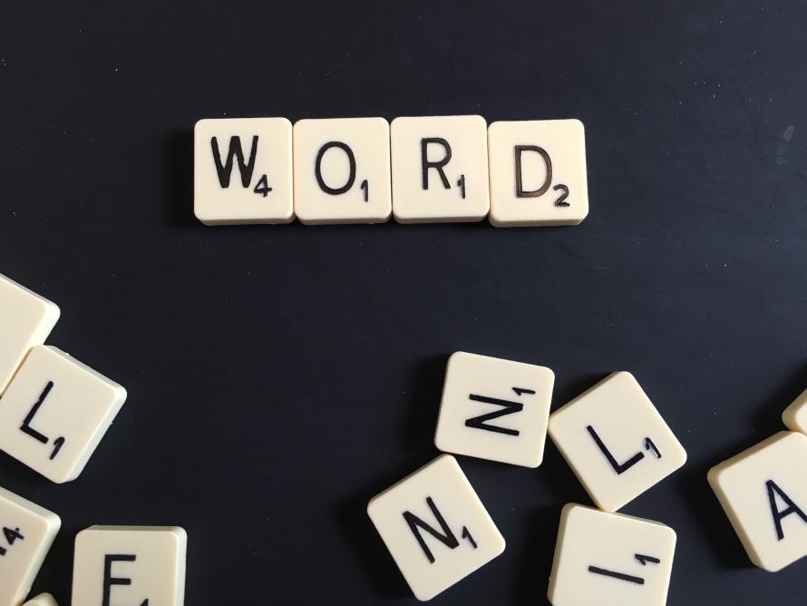 Scrabble letters spelling the word “word”.