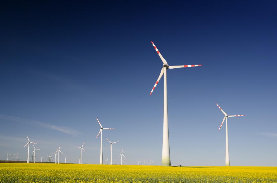 Windmills on grass field at daytime.